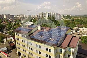 Aerial view of many solar panels mounted of industrial building roof