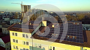 Aerial view of many solar panels mounted of industrial building roof.