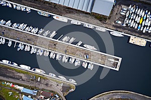 Aerial view of Marina with boats and yachts from above in row and pontoon