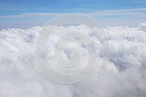 Aerial view of massive clouds and beautiful summer blue sky from aircraft window.Image use for environment and meteorology