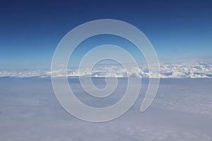 Aerial view of massive clouds and beautiful summer blue sky from aircraft window.Image use for environment and meteorology