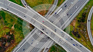 Aerial view massive highway intersection, stack interchange with elevated road junction overpass at early morning in