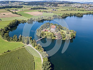 Aerial view of the Mauern Lake with an old, little castle on the small island,