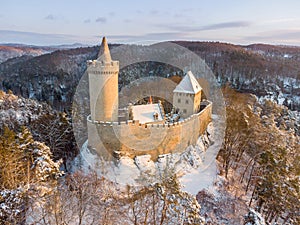 Aerial view of medieval castle Kokorin in winter during sunrise. National park Kokorinsko nearby Prague in Czech