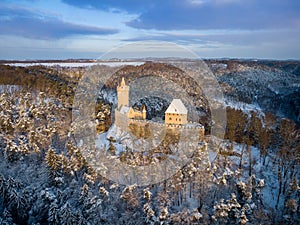 Aerial view of medieval castle Kokorin in winter during sunrise. National park Kokorinsko nearby Prague in Czech