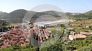 Aerial view from the medieval fortifications over the small town of Ston and the historic salt pans. Dubrovnik area, Croatia