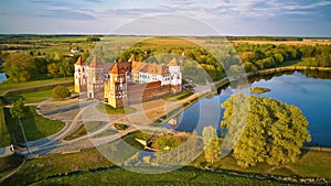 Aerial view of Medieval Mir castle complex at spring sunset. UNESCO world heritage