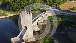 Aerial view of a medieval stone bridge over Ebro river in Frias, historic village in the province of Burgos, Spain