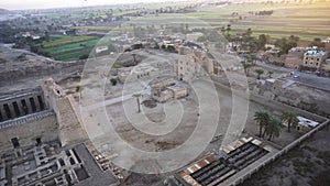 Aerial view Medinet Habu temple from hot air balloon with Valley of the kings village background Luxor Egypt