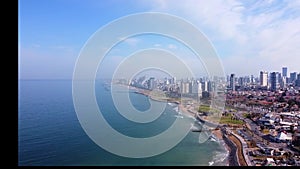 Aerial view the Mediterranean Sea with the blue color of the water washes the embankment of Tel Aviv. Skyscrapers