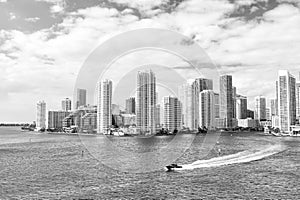 Aerial view of Miami skyscrapers with blue cloudy sky, boat sail