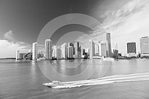 Aerial view of Miami skyscrapers with blue cloudy sky, boat sail