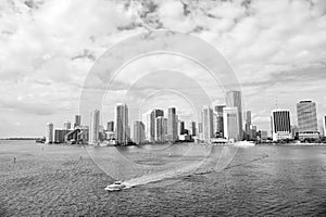 Aerial view of Miami skyscrapers with blue cloudy sky, boat sail