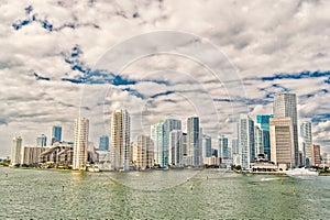 Aerial view of Miami skyscrapers with blue cloudy sky, boat sail