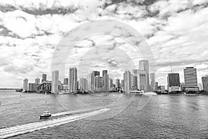 Aerial view of Miami skyscrapers with blue cloudy sky, boat sail