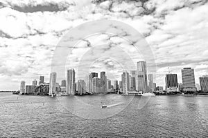 Aerial view of Miami skyscrapers with blue cloudy sky, boat sail