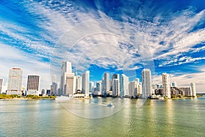 Aerial view of Miami skyscrapers with blue cloudy sky, boat sail