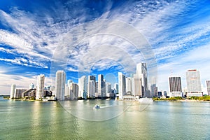 Aerial view of Miami skyscrapers with blue cloudy sky, boat sail