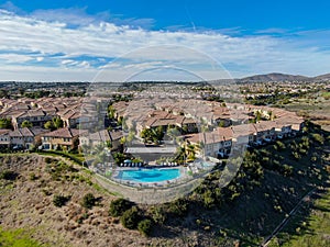 Aerial view of middle class neighborhood with identical residential subdivision house and compound swimming pool