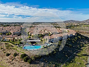 Aerial view of middle class neighborhood with identical residential subdivision house and compound swimming pool