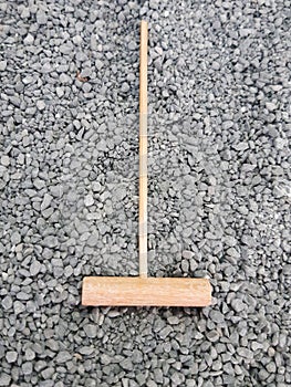 Aerial view of mini zen bamboo rake on small gray stones. Japanese garden. Oriental decoration and meditation. Karesansui