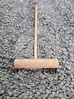 Aerial view of mini zen bamboo rake on small gray stones. Japanese garden. Oriental decoration and meditation. Karesansui