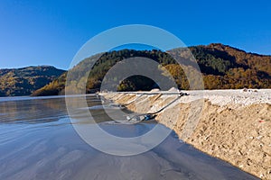 Aerial view of mining residual waters from a copper mine discharging into decanting pond. Geamana, Romania