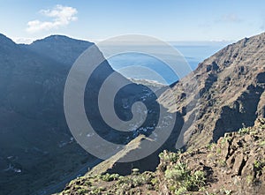 Aerial view from Mirador de la curva del queso. Green valley of Valle Gran Rey with mountain cliffs, ocean and colorful photo