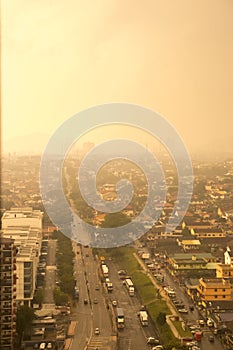 Aerial view of mist and pollution above city in sunlight