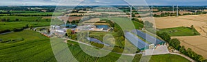 Aerial view of modern agriculture farm with agricultural fields with corn, biogas plant.