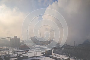 Aerial view of modern combined heat and power plant. Fuming chimney. Heavy industry from above. Power and fuel generation in