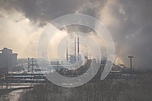 Aerial view of modern combined heat and power plant. Fuming chimney. Heavy industry from above. Power and fuel generation in