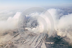 Aerial view of modern combined heat and power plant. Fuming chimney. Heavy industry from above. Power and fuel generation in