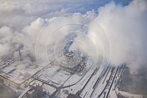 Aerial view of modern combined heat and power plant. Fuming chimney. Heavy industry from above. Power and fuel generation in