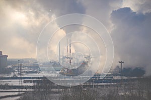 Aerial view of modern combined heat and power plant. Fuming chimney. Heavy industry from above. Power and fuel generation in