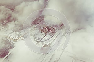 Aerial view of modern combined heat and power plant. Fuming chimney. Heavy industry from above. Power and fuel generation in