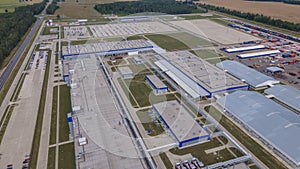 Aerial view of modern factory. Industrial territory and many cars nearby from above. Industrial concept