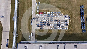 Aerial view of modern factory. Industrial territory and many cars nearby from above. Industrial concept