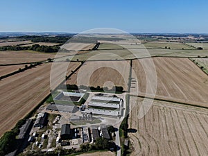 Aerial view of modern farm yard showing neat buildings and surrounded by ploughed fields