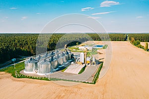 Aerial View Modern Granary, Grain-drying Complex, Commercial Grain Or Seed Silos In Sunny Spring Rural Landscape. Corn