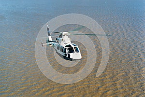 aerial view of a modern helicopter with 2 squalls flying over the - rio de la plata -, buenos aires, photo maqueira