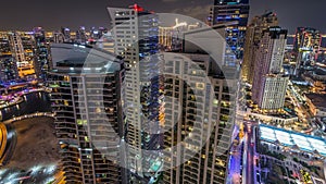 Aerial view of modern illuminated skyscrapers at Jumeirah Beach Residence JBR and Dubai marina night timelapse in Dubai