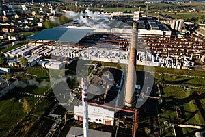 Aerial view of modern large industrial factory with smokestack,