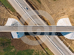 Aerial view of modern new highway road with transportation junction for traffic, drone shot