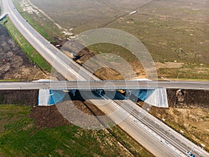 Aerial view of modern new highway road with transportation junction for traffic, drone shot