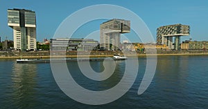 Aerial view of modern Office Buildings with Glass front next to a river with the skyline and cathedral of cologne in the