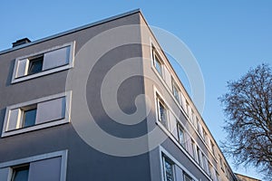 a modern residential building on a street corner in the sun