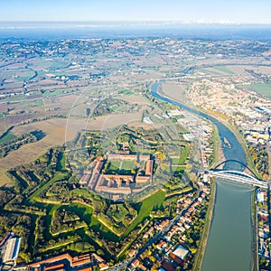 Aerial view of modern six-star hexagon shaped fort Cittadella of Alessandria on winding river Tanaro. Piedmont, Italy. photo