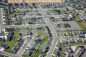 An aerial view of a modern subdivision in a medium sized city.