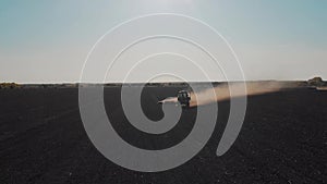 Aerial view modern tractor on the agricultural field on sunset time. Tractor plowing land and cultivating field.